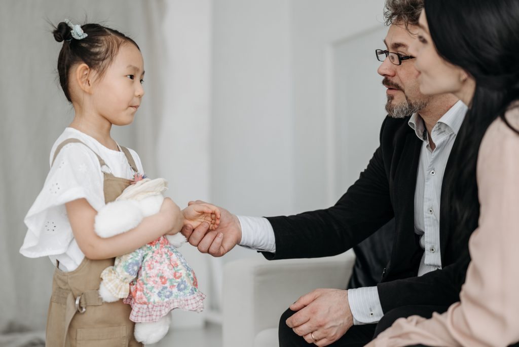 girl shaking hands with a man in a suit